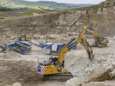Excavators and crushers operating in a quarry site